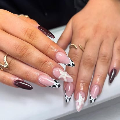 Burgundy almond nails with cow print french and 3D bows